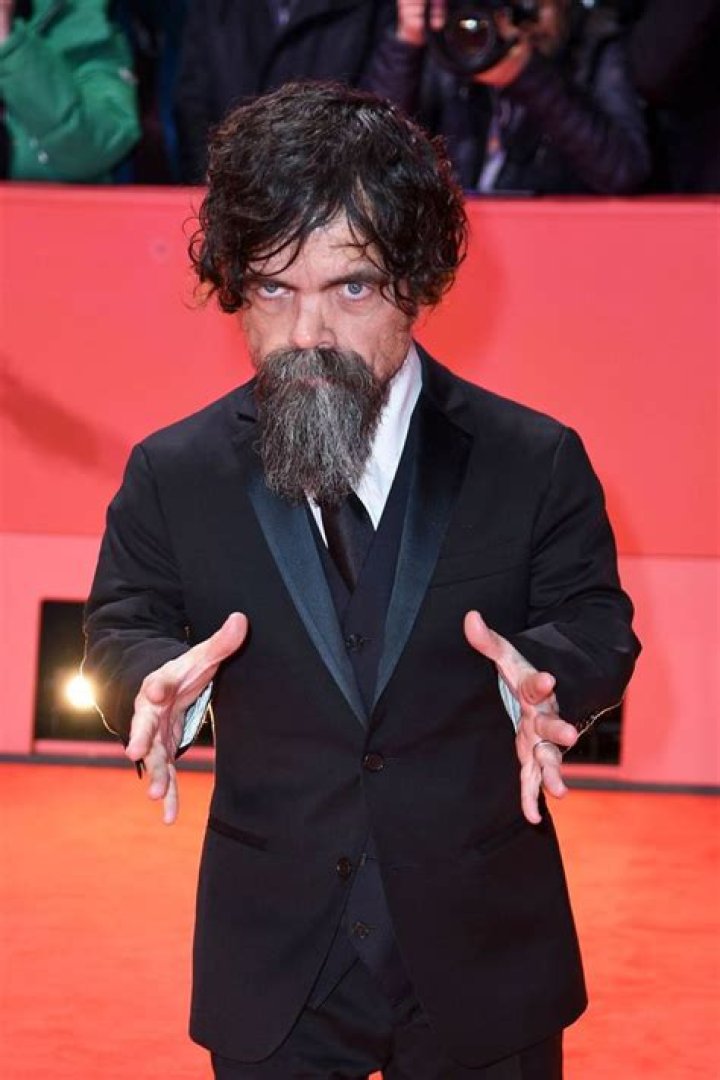Peter Dinklage's daughter stays warm beneath a pair of enormous red ear